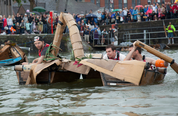 People taking part in cardboard boat racing as part of the Bristol Harbour Festival