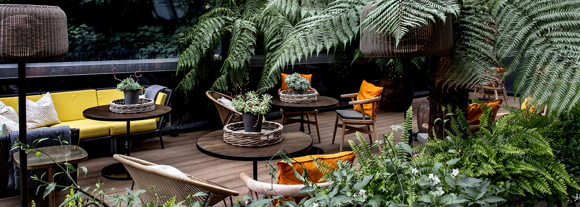 Outdoor terrace with seating and greenery