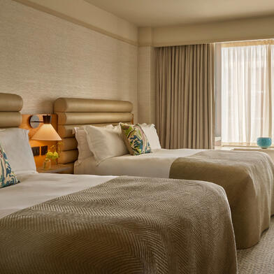 Guest room at The River Lee Hotel, showcasing a bright and stylish setup with two single beds