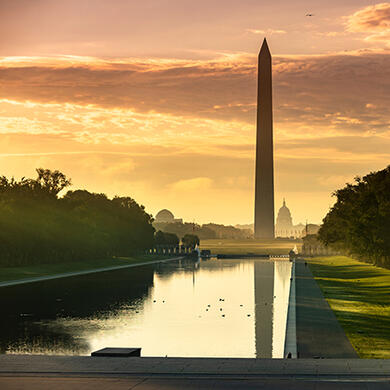 The National Mall in Washington, DC at dusk, illuminated by sunset skies and evening light.