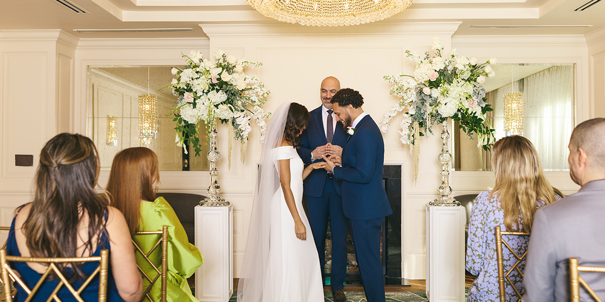 An intimate "I do" moment at The Dupont Circle, showcasing a beautiful city wedding ceremony in a sun-filled, sophisticated event space.