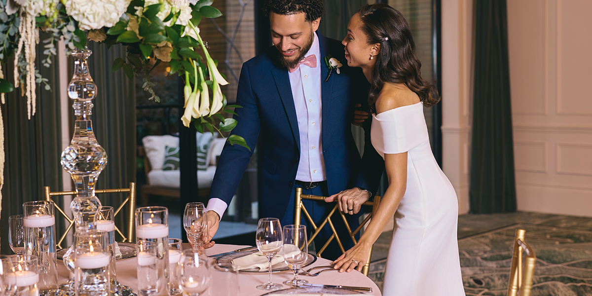 A bride and groom admiring the floral arrangements and elegant table settings at their wedding reception at The Dupont Circle in Washington DC.