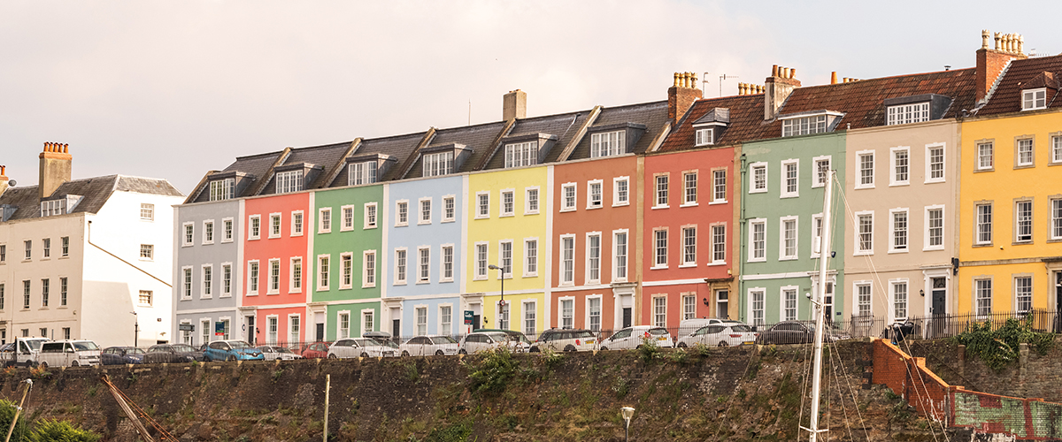 An autumnal scene showing the vibrant, colorful buildings along Bristol's Harbourside.