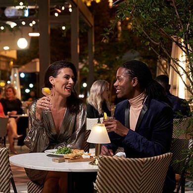 Two stylish women dining at a table in The Pembroke restaurant at The Dupont Circle Hotel.