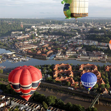 Hot air balloons flying over the city