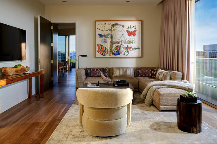 The Grand Luxury Terrace Suite iving area with art on the walls 