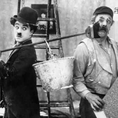 Charlie Chaplin with bucket and broom