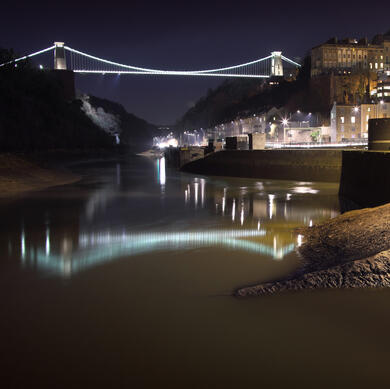 Clifton Suspension Bridge at night with reflection in the water