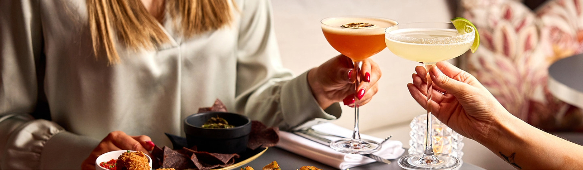 Guests at Rick’s Bar in Bristol enjoying finger food alongside two martinis.