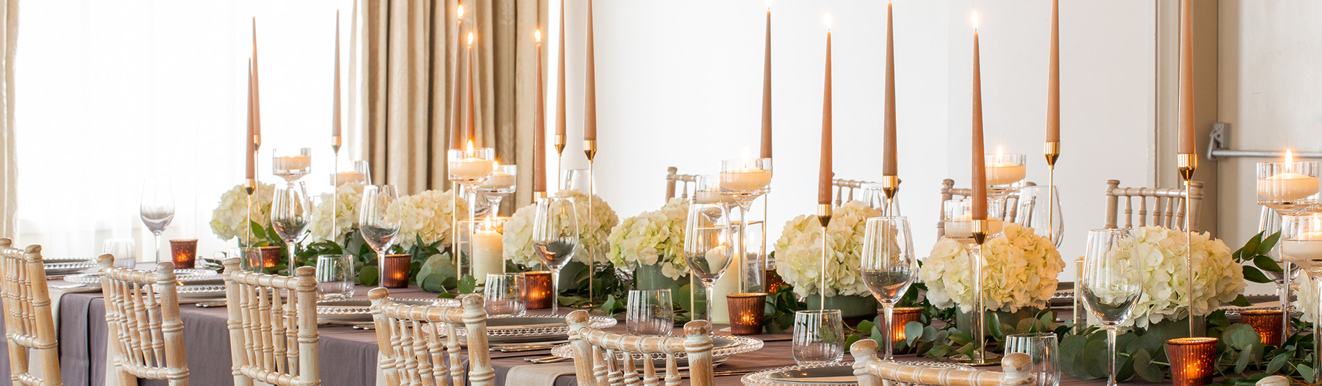 Long table decorated with long candles and flowers