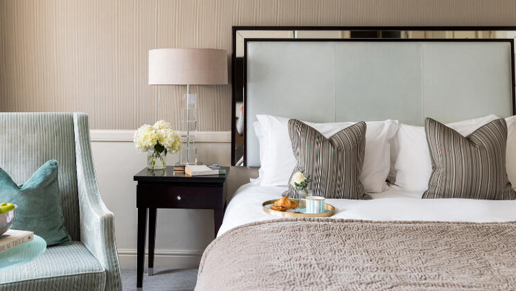 Cozy hotel room in Bristol with a cup of coffee on the bed, perfect for a Spring Escape getaway.