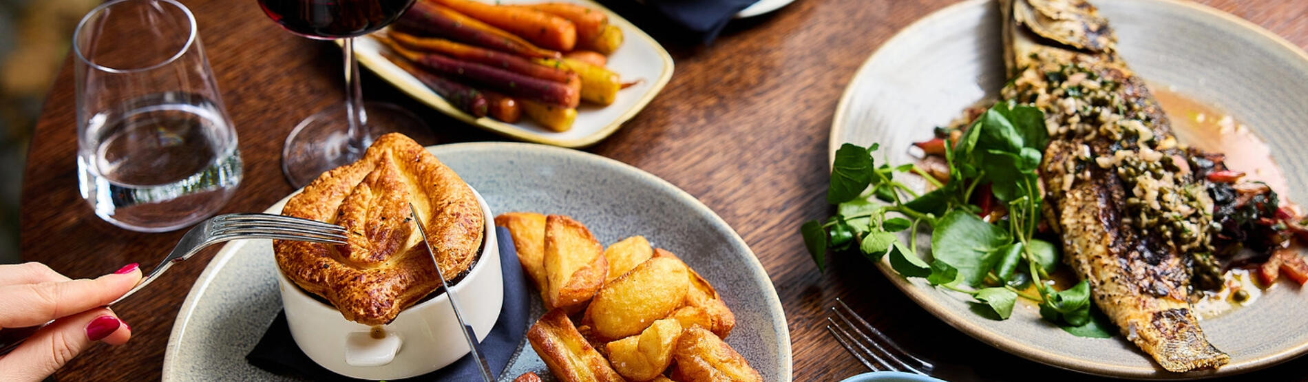 A beautifully presented 3-course pre-theatre dinner at The River Grille, featuring a savory pie, and fish and veggies, and two glasses of wine.