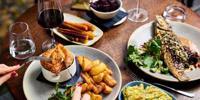 A beautifully presented 3-course pre-theatre dinner at The River Grille, featuring a savory pie, and fish and veggies, and two glasses of wine.