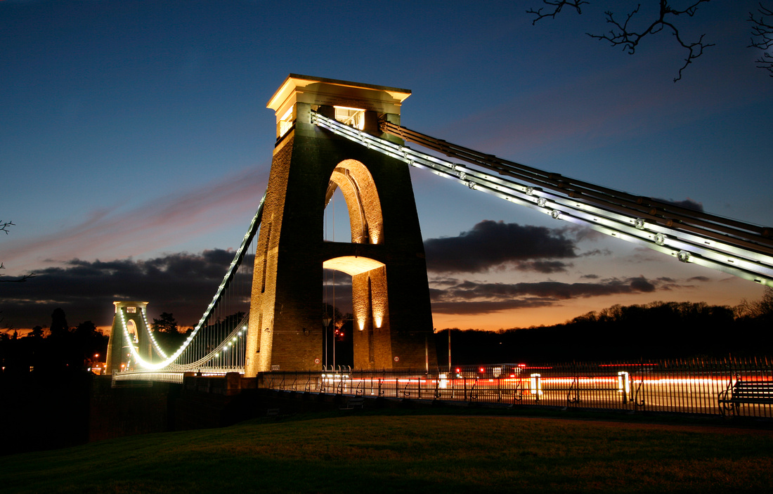 The Bristol Suspension Bridge illuminated at night, showcasing a spectacular view.