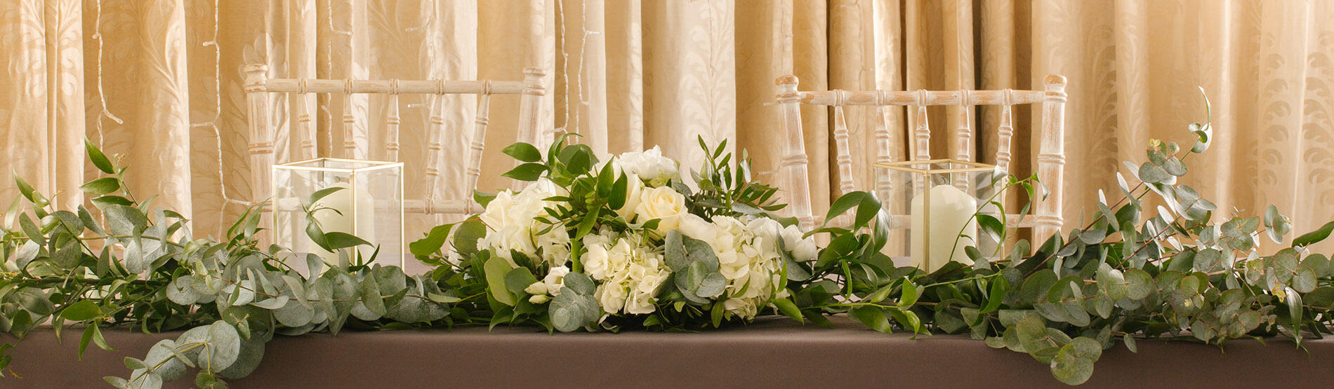 Wedding table decorated with flowers and candles