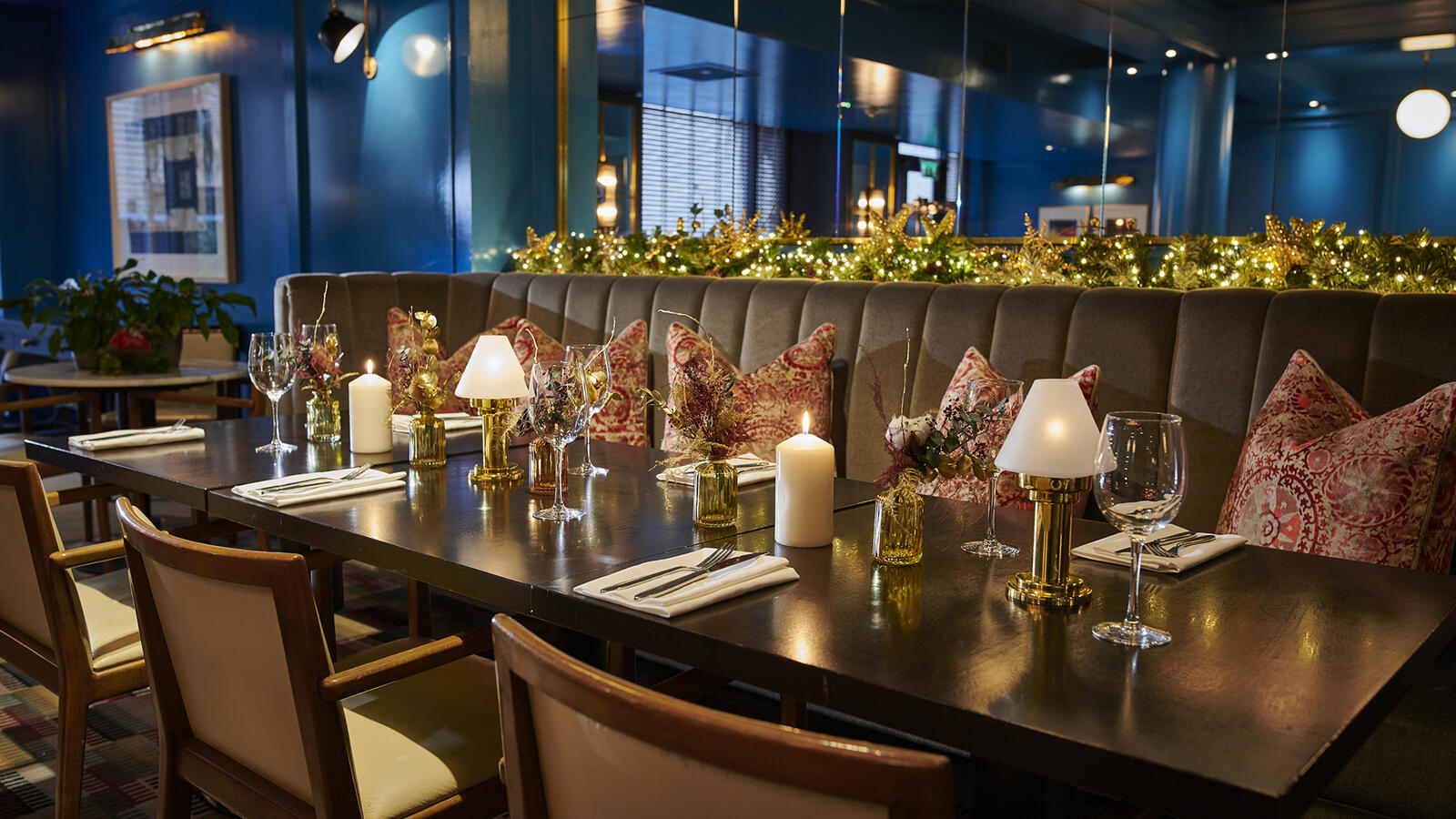 Festive restaurant interior at Croke Park hotel with Christmas lights, candles, and dining settings.