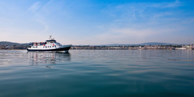 Dublin Bay Cruise boat traveling on the sea from Howth to Dún Laoghaire, featured in the family staycation package at The Croke Park hotel.