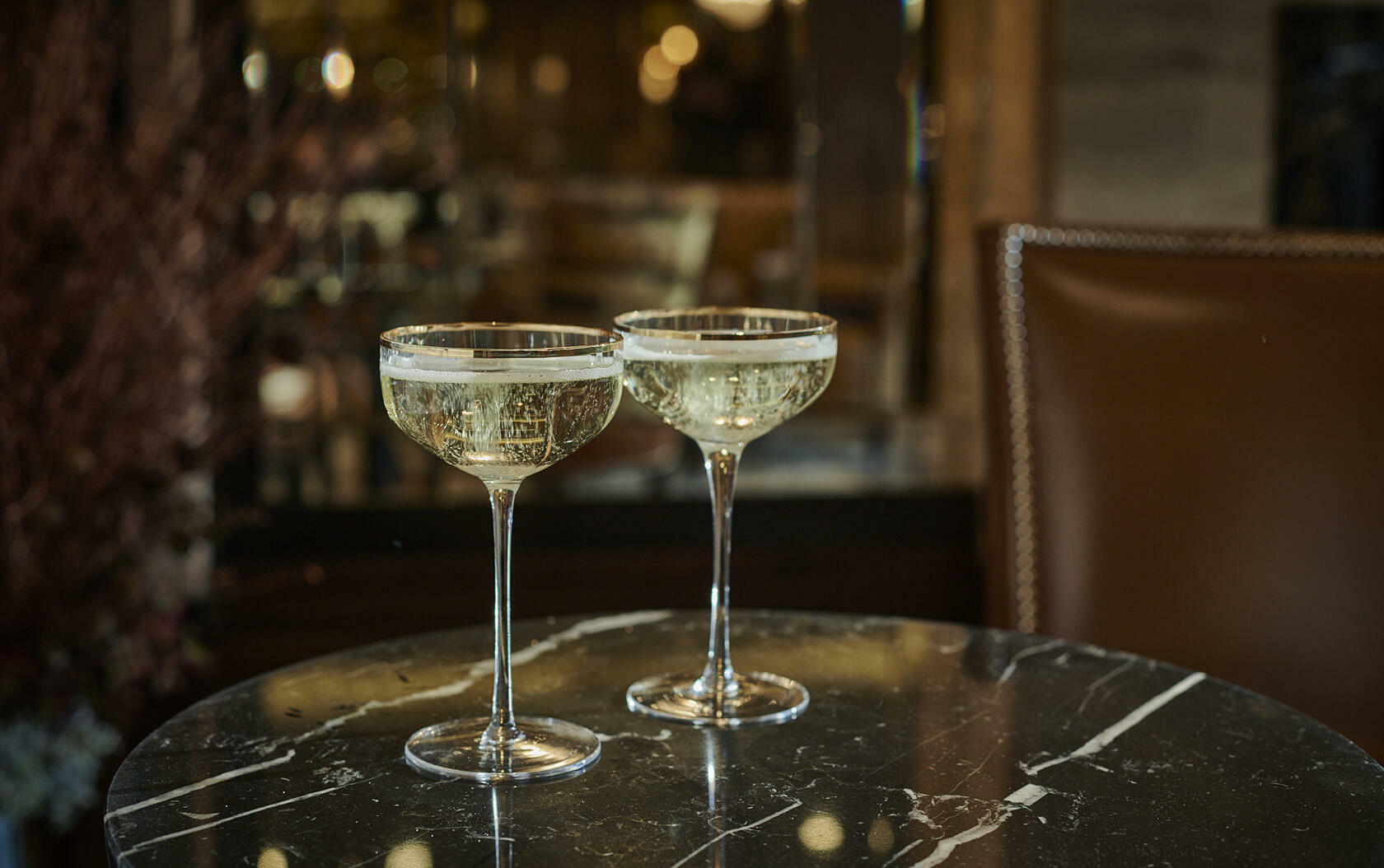 Two champagne filled Sidecar Cocktail Coupe glasses 