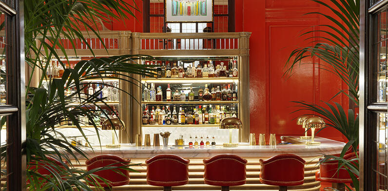 Coral room bar with coral coloured walls and bar stools