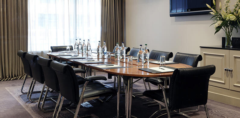 meeting room set boardroom style with floral display