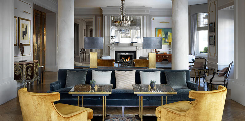 Blue Sofa with gold arm chairs in the Drawing Room