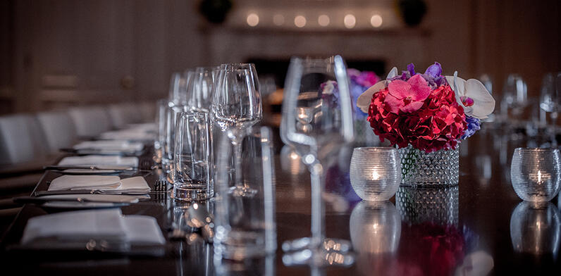 table set for private dining with red floral arrangement