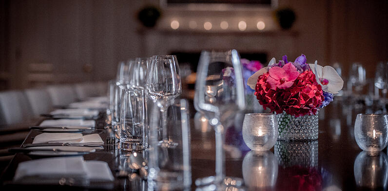 private dining room table decorated with red flowers
