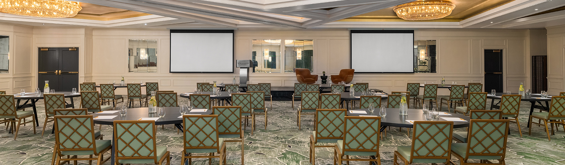 An airy view of The Dupont Ballroom set for a seminar. The crescent round tables are neatly arranged to maximize visibility and collaboration
