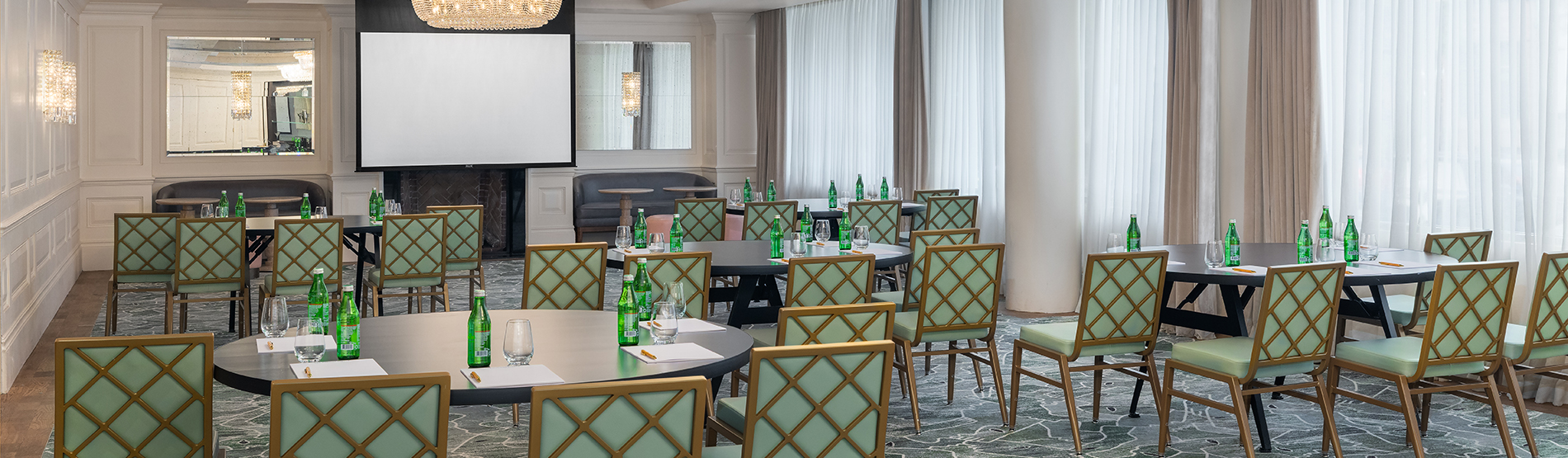 A bright view of the Foxhall room’s crescent round setup. The organized seating and elegant table arrangements create a professional yet comfortable environment for a collaborative seminar.