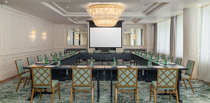 Meeting tables in the Foxhall room set in a hollow square, with chairs positioned around the perimeter facing inward.