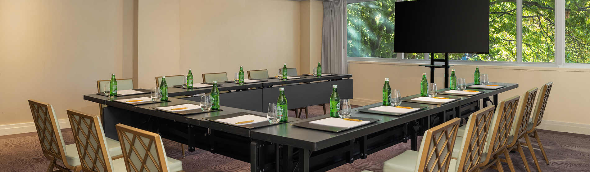 Wide-angle view of the Georgetown Room set in a U-shape for a meeting in The Dupont Circle hotel in Washington DC.