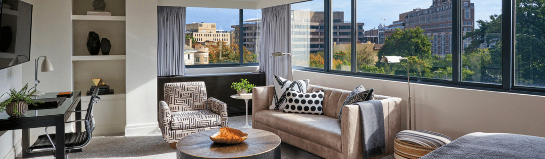 Junior Suite with large windows overlooking the city