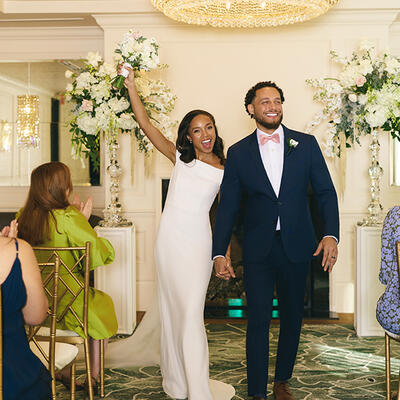 Newlyweds walking down the aisle or embracing at their Foxhall wedding ceremony