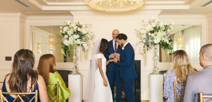 A joyful wedding ceremony at Foxhall in The Dupont Circle Hotel, capturing the couple’s first moments after being pronounced husband and wif