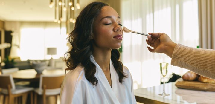Bride having her makeup done while getting ready in a suite at The Dupont Circle Hotel, Washington DC