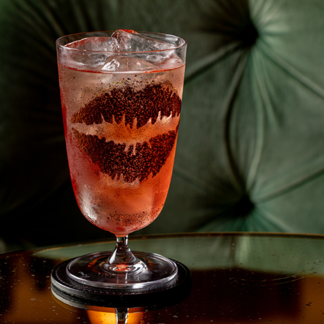 Red cocktail with a kiss-print garnish on the glass rim, part of the Schiaparelli couture afternoon tea experience at The Kensington, South Kensington.