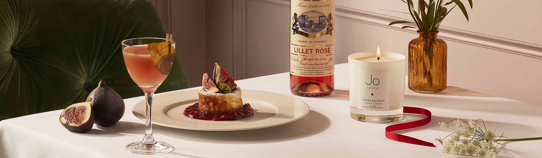 Lillet rose wine, jo loves candle and a festive dish served at the Kensington