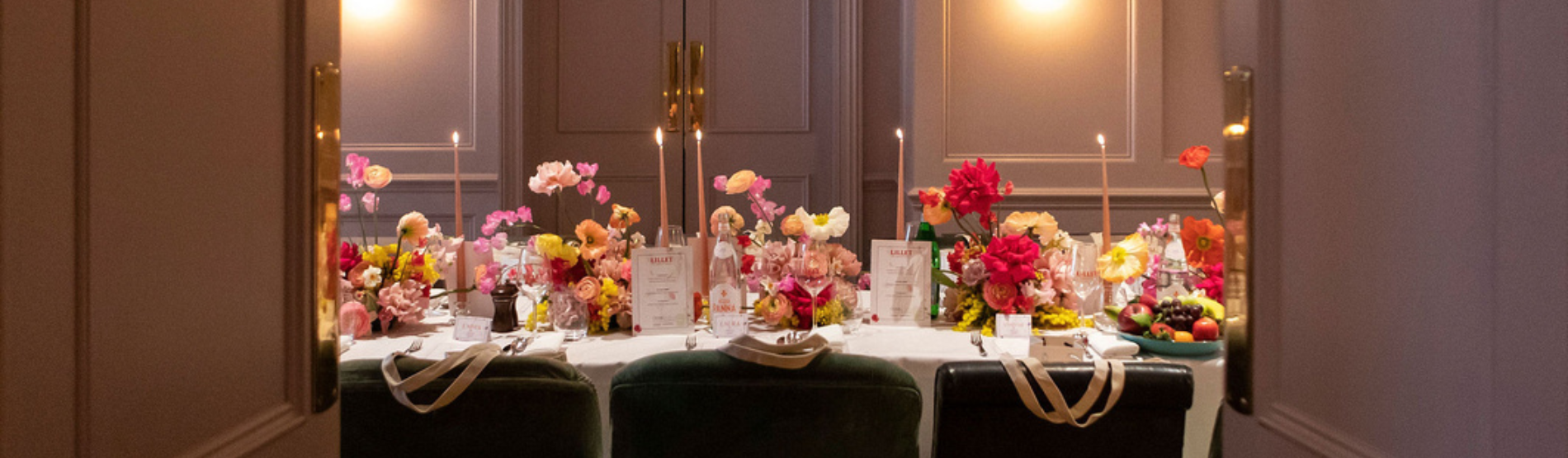 Intimate dining setup in The Study at The Kensington, featuring a beautifully decorated table with vibrant floral arrangements, tapered candles, and elegant place settings — ideal for private events and celebrations in a refined setting.