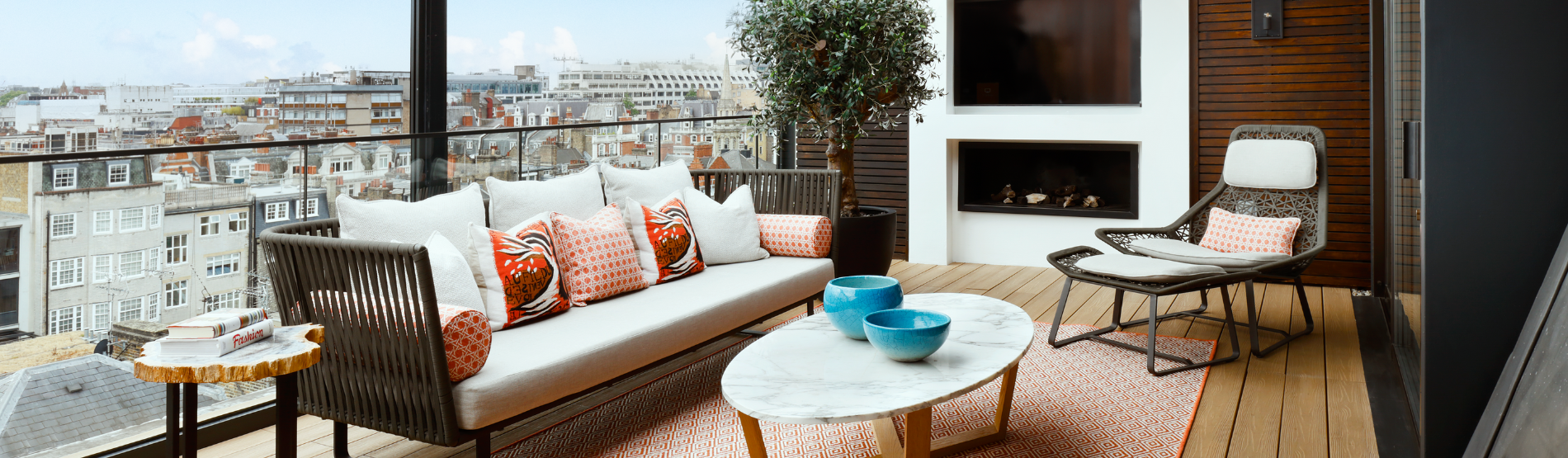 A luxurious balcony at The Marylebone Hotel suite, featuring comfortable seating and a view of London city, part of the Suite Health wellness package.