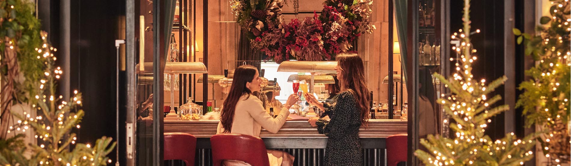 Two ladies enjoying their stay at The Marylebone Hotel during Christmas celebrations