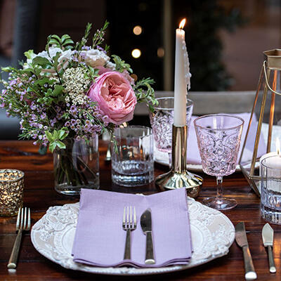 Table setting with crockery, flowers and candle