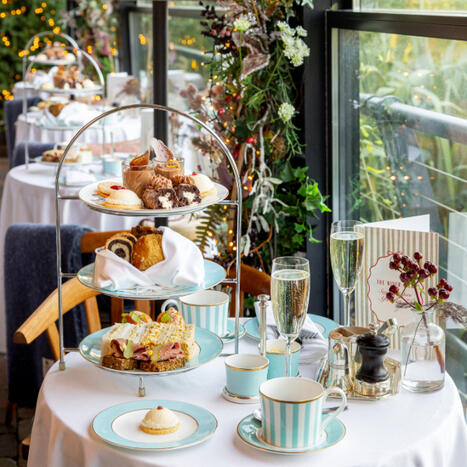 A perfectly set afternoon tea at The River Lee Hotel, featuring a three-tier stand and two champagne, perfect for a relaxing afternoon.