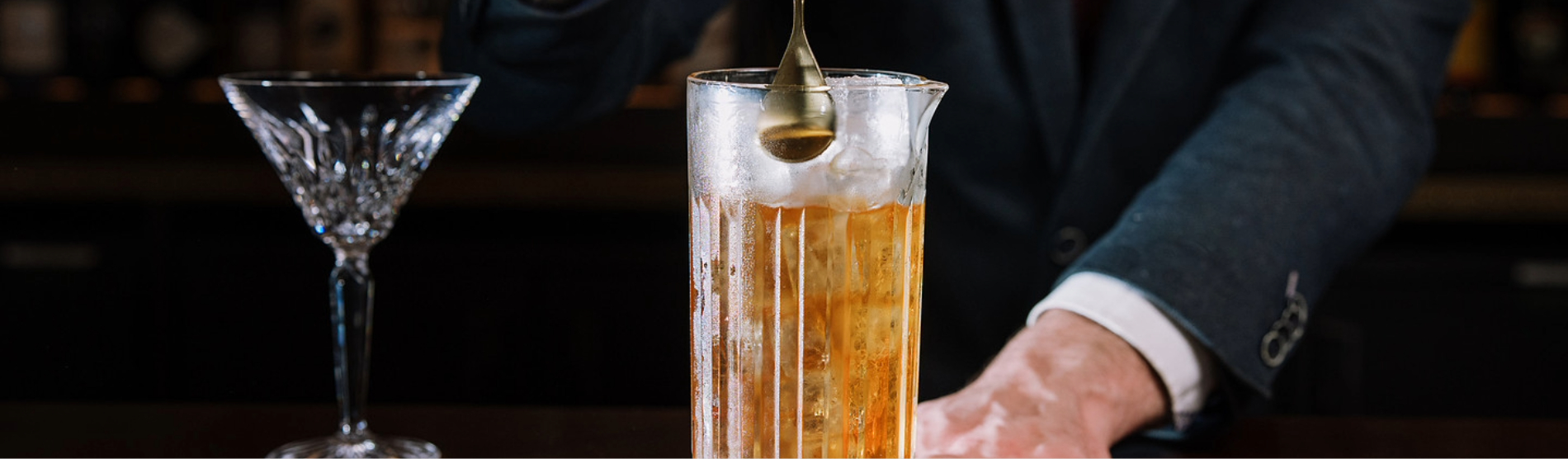 Behind the bar at The River Club, Cork: a mixologist preparing a cocktail.