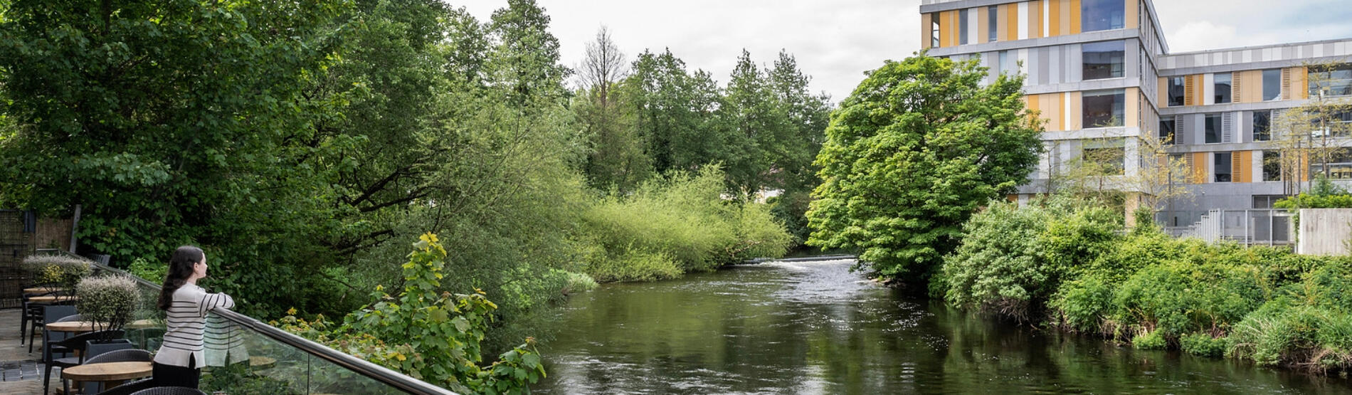 Riverside dining terrace at The River Lee hotel, Cork city, with views of the green riverbank and water