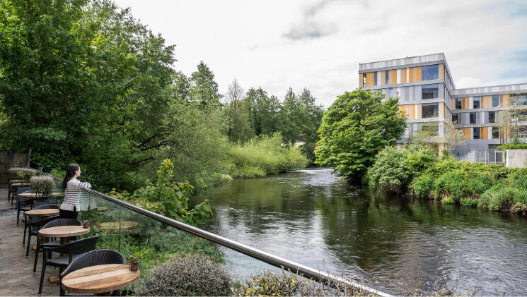 Riverside dining terrace at The River Lee hotel, Cork city, with views of the green riverbank and water