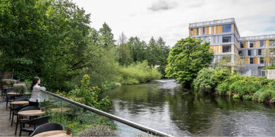 Riverside dining terrace at The River Lee hotel, Cork city, with views of the green riverbank and water