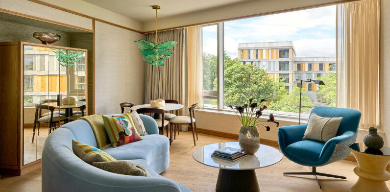 Luxury suite at The River Lee Hotel, featuring a stylish sofa, table, and large windows.