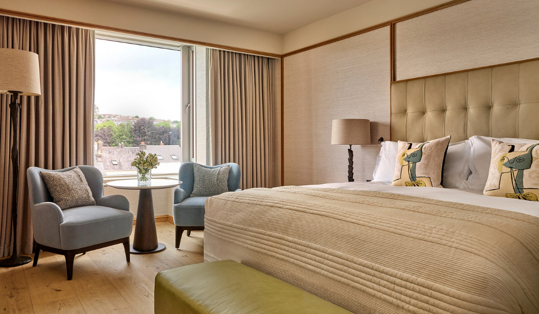 Luxury Suite Bedroom Illustration: King bed and window seating area at The River Lee Hotel