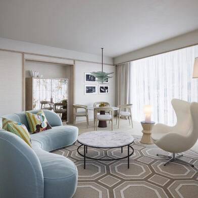 llustrative view of the Luxury Suite seating area at The River Lee, featuring a large sofa bed, armchair, and a 4-person dining table in a bright, sunlit room
