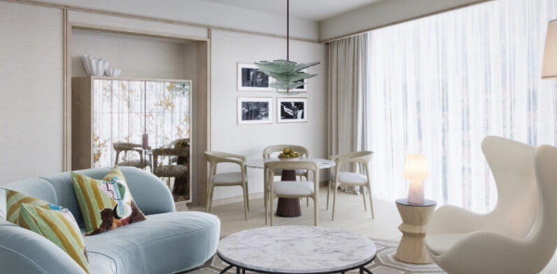 llustrative view of the Luxury Suite seating area at The River Lee, featuring a large sofa bed, armchair, and a 4-person dining table in a bright, sunlit room